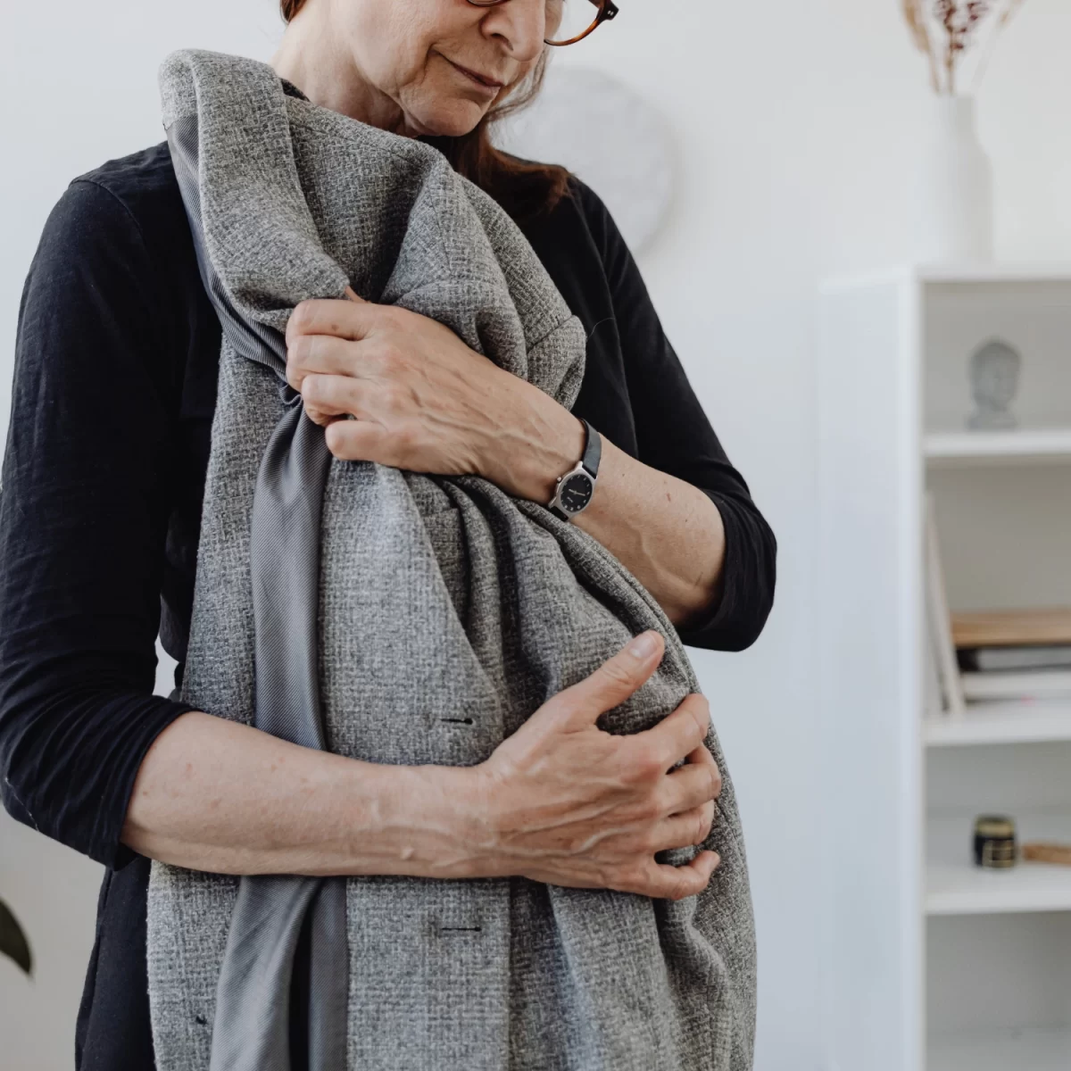 Woman holding the jacket of a loved one.