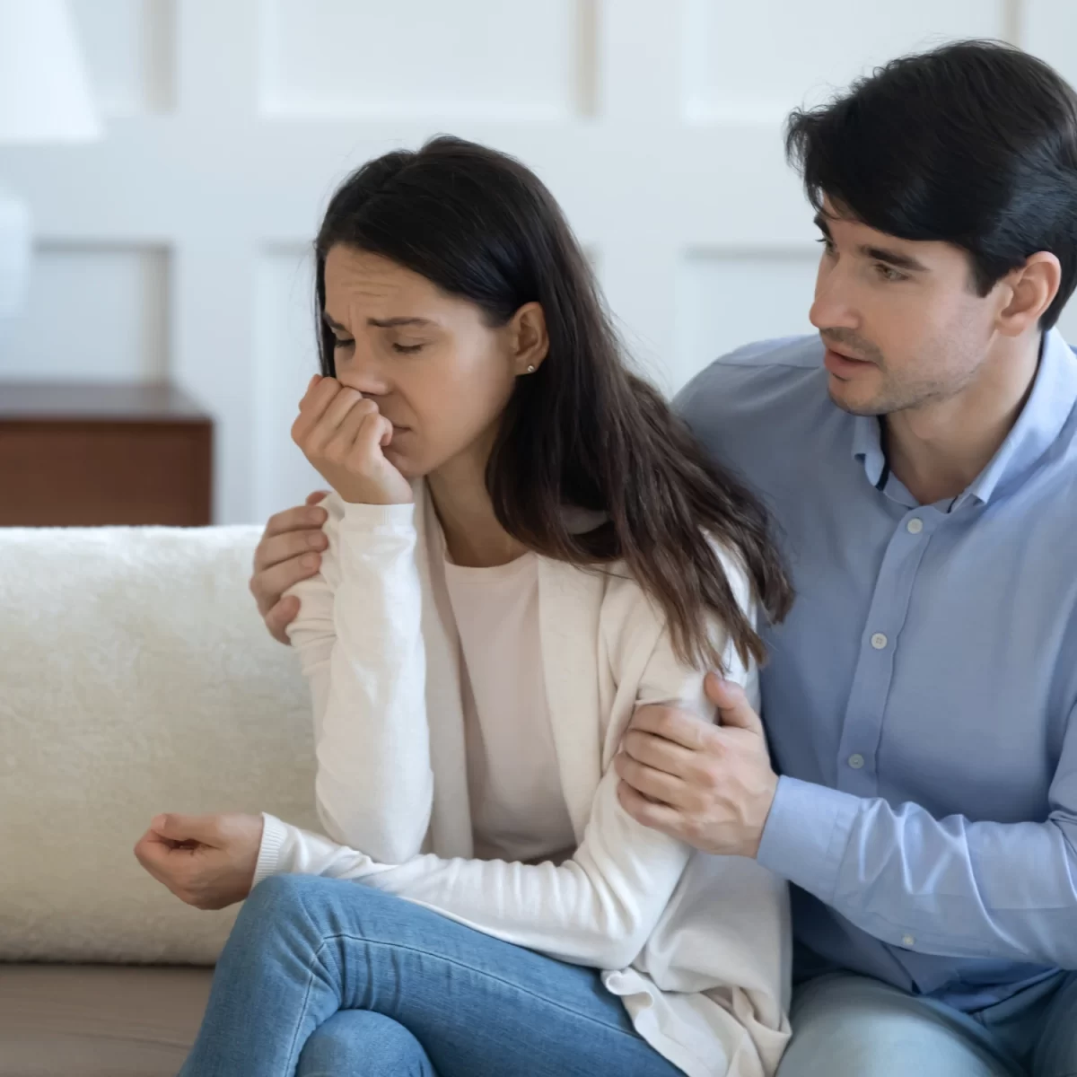 Male partner comforting grieving female partner