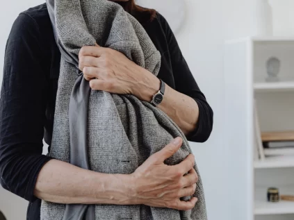 Woman holding the jacket of a loved one.